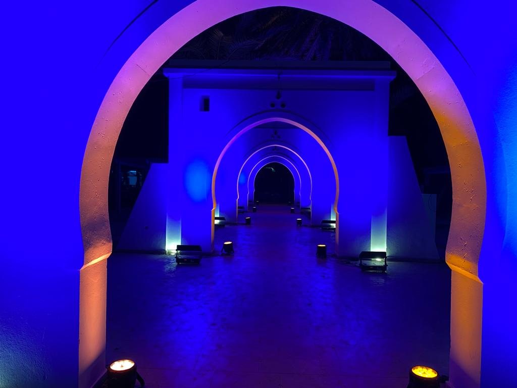 The Arcades: a succession of arches lit in blue and magenta inside the former olive mill