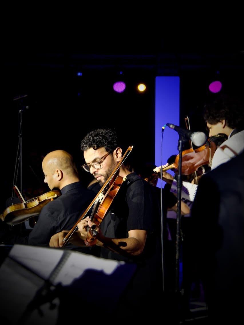 The violinists on stage inside the ring of LED pillars