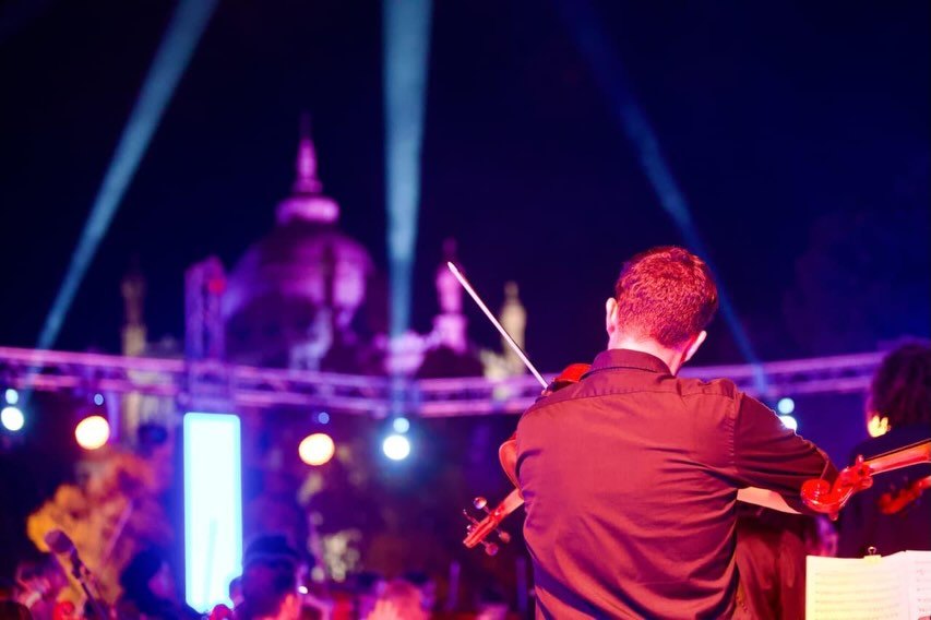 The violinists on stage inside the ring of LED pillars