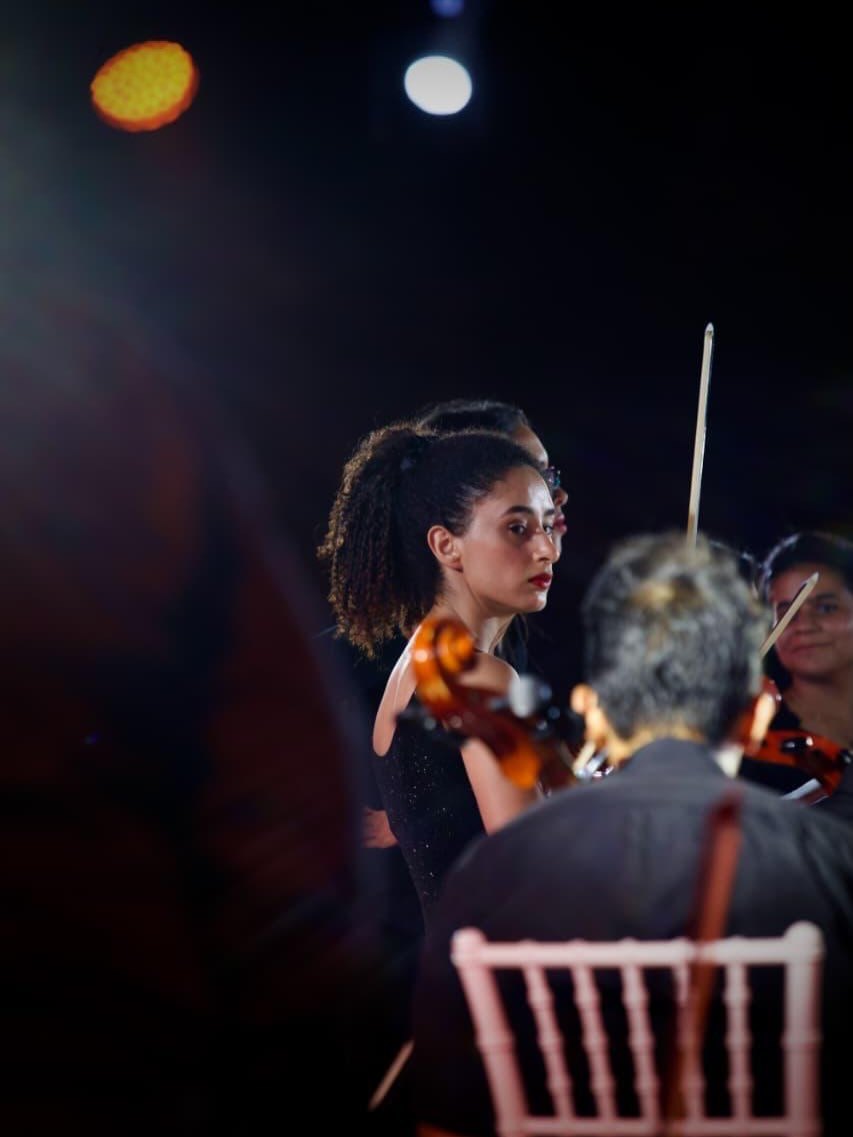 The violinists on stage inside the ring of LED pillars